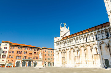 Chiesa di San Michele in Foro St Michael Roman Catholic church basilica on Piazza San Michele square in historical centre of old medieval town Lucca in summer day with clear blue sky, Tuscany, Italy