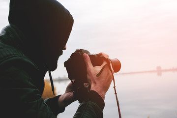 young photographer takes pictures of the lake