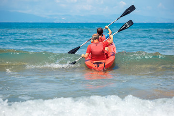 Father and son kayaking in ocean. Active vacation with young kid. Holiday activity with schoolboy child