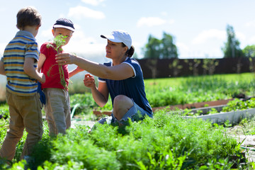 Woman and her children in garden