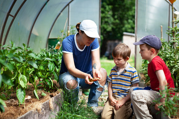 Woman and her children in garden