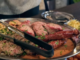 meat dish with sausages on a table in a restaurant
