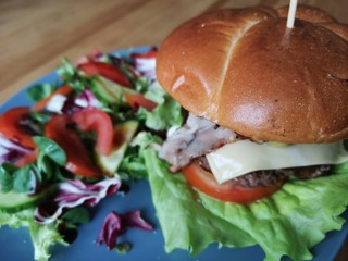 burger with fresh salad and cheese on the table