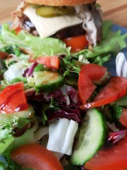 burger with fresh salad and cheese on the table