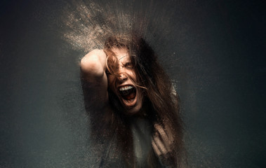 Screaming crazy frustrated woman dispersing into million particles, anxiety, anger and depression...
