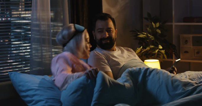 Couple in bed before sleeping