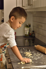 Fototapeta na wymiar Boy cooking kid playing healthy baking delicious