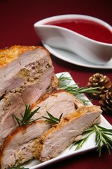 baked pork fillet with herbs on red tablecloth