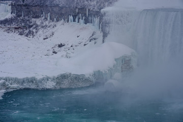 Ice several feet thick at the base of the american side of the Niagara waterfalls as seen from the Canadian side