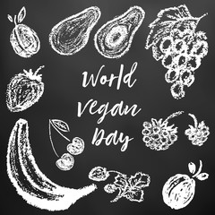 Children's drawing of white chalk on a black board. World Vegan Day. Plum, avocado, grapes, raspberries, strawberries, cherries, strawberries, banana, apricot