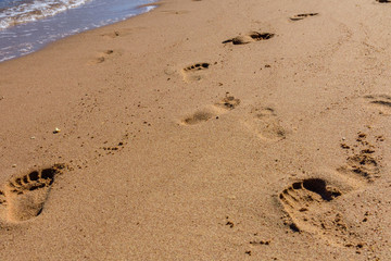 Human footprints on the sandy beach. Summer vacation concept