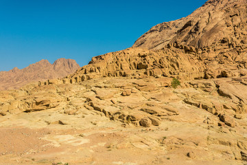 Fototapeta premium Middle East or Africa, picturesque bare mountain range and a large sandy valley desert landscapes landscape photography