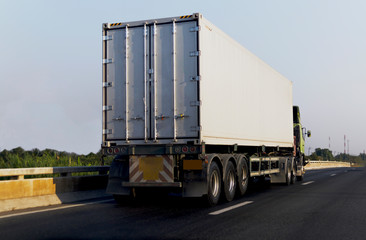 White Truck on highway road with  container, transportation concept.,import,export logistic industrial Transporting Land transport on the asphalt expressway