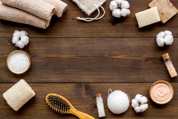 Organic cosmetics and eco materials for homemade spa on wooden background top view mock up