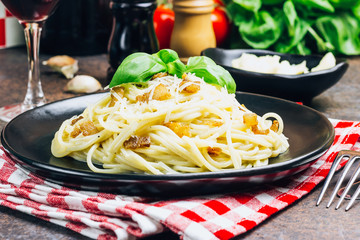 Italian pasta spaghetti Carbonara with fried bacon, parmesan cheese and parsley on white plate. Restaurant food concept