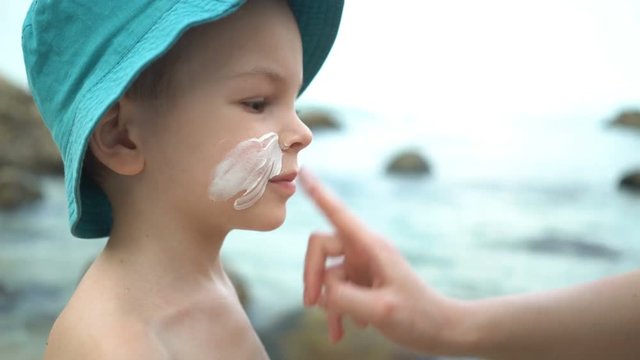 mom masks her son with sunblock cream