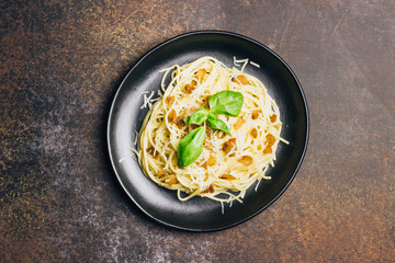 Italian pasta spaghetti Carbonara with fried bacon, parmesan cheese and parsley on white plate. Restaurant food concept