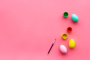paint eggs for Easter celebration on pink background top view mock up