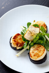 Scallops with black pudding and apple and pea shoots salad