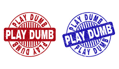 Grunge PLAY DUMB round stamp seals isolated on a white background. Round seals with grunge texture in red and blue colors. Vector rubber overlay of PLAY DUMB tag inside circle form with stripes.