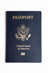 The iconic blue cover of an American passport deliberately and artistically set on a plain white...
