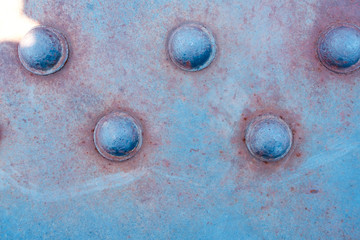 Rusty steel plate with big rivets, old railroad bridge parts.