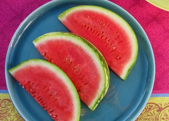 Chilled, refreshing watermelon slices on blue plate