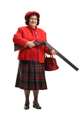 Elderly lady charging a shotgun and smiling