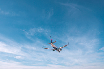 Naklejka na ściany i meble Aviation, travel, air transportation concept. Airplane in blue sky