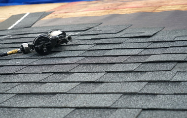 close up on nail gun on the roof shingle © nd700