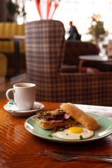 Ciabatta with oyster mushrooms, ham and fried egg for breakfast