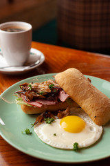 Ciabatta with oyster mushrooms, ham and fried egg for breakfast