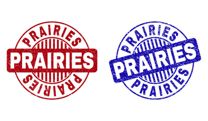Grunge PRAIRIES round stamp seals isolated on a white background. Round seals with distress texture in red and blue colors. Vector rubber overlay of PRAIRIES text inside circle form with stripes.