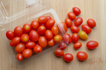 Red ripe tomatoes on wooden table
