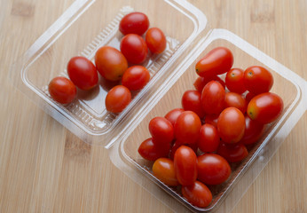 Red ripe tomatoes on wooden table