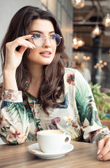 Portrait of a woman in cafe during breakfast.