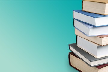 Stack of colorful books on  background