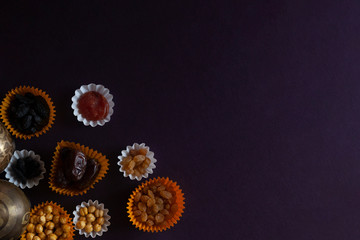 Eid Mubarak. Different iftar sweets. Celebrating Eid Al Adha. Islamic traditional holiday. Eid al-Fitr. Holly month Ramadan. Middle Eastern religious holiday. Dried date fruit. Flat lay, top view.