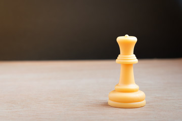 Fototapeta na wymiar White chess queen with black background