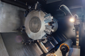 Turret head of CNC lathe tool. Rotating part for working tool change, close up