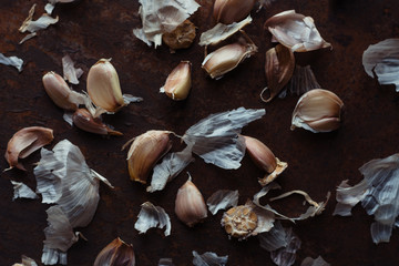 Garlic cloves on rusty metal
