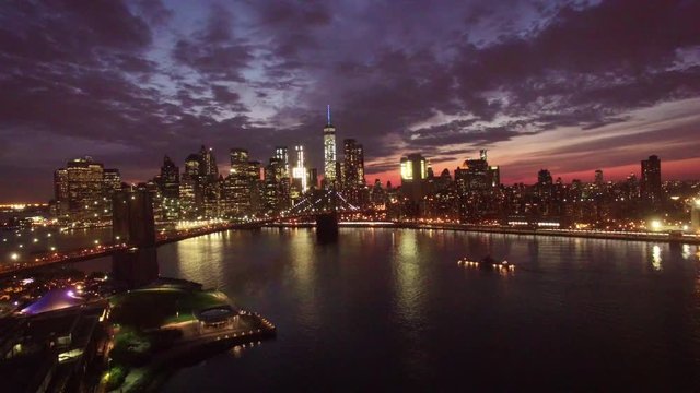 24P flying away from Manhattan over bridge