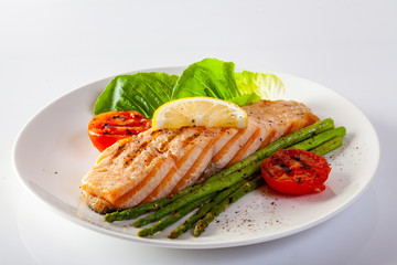 Roasted salmon steak with asparagos tomatoes  with fresh vegetable.