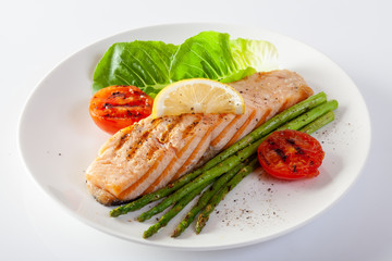 Roasted salmon steak with asparagos tomatoes  with fresh vegetable.