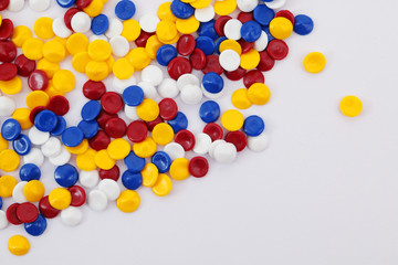 colorful industrial plastic pellets on white background