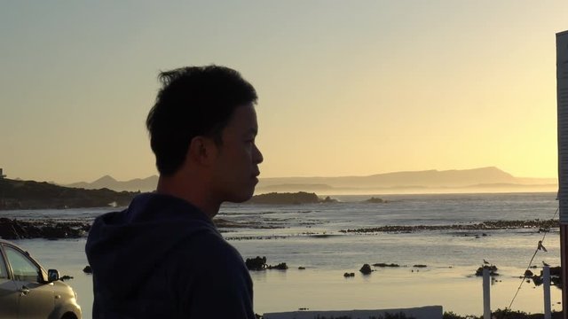 Asian Man At Sunrise Sea South Africa