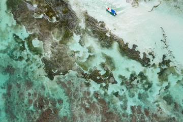 Aerial view on caribbean sea with floating boat