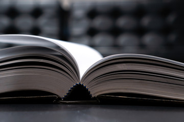 Reading old textbook in university library, read book or relaxing in vintage black background. Reading is complex cognitive process of decoding symbols to derive meaning communication information.