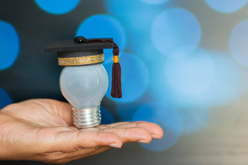 Education or Graduate study Creative concept: Mini Graduated hat with light bulb
