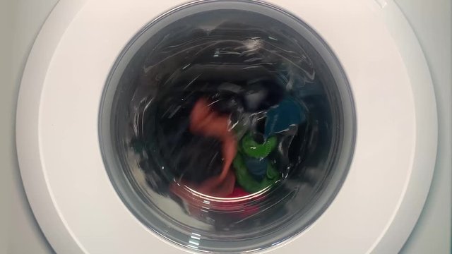 Working washing machine in slowmotion. Washing machine is working and then it suddenly fail and stops working. End of time, time out.